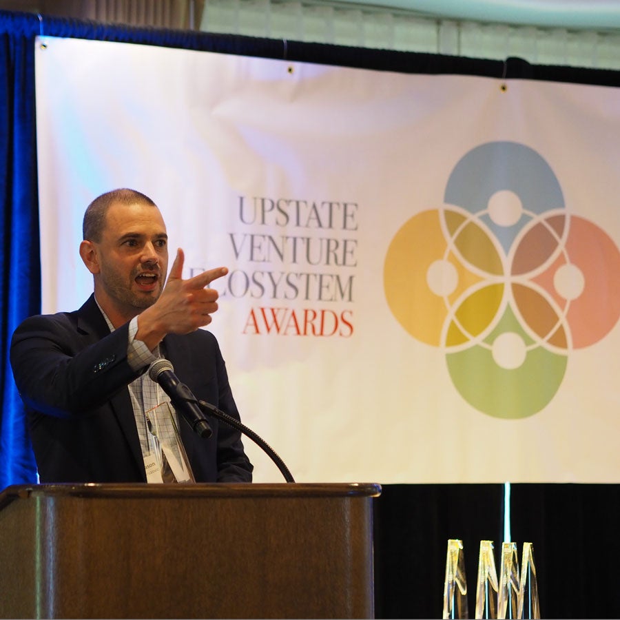 Severino Center Director, Jason Kuruzovich accepts an Upstate Venture Ecosystem award